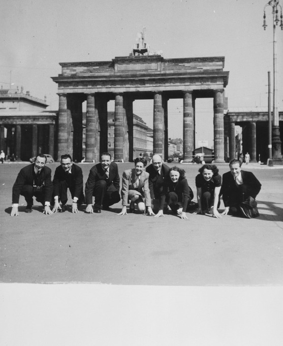 A company of French singers and dancers poses in front of the Brandenburg Gate while on a performance tour in Germany. Sadie Rigal, who is actually a Jew in hiding, is pictured in the centre. Date: 1943. (On the far left is her dance partner, Frederic Apcar. Edith Piaf is show third from the right.) Photo Credit: United States Holocaust Memorial Museum, courtesy of Sadie Rigal Waren.